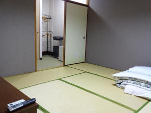 Postel nebo postele na pokoji v ubytování Imazato Ryokan