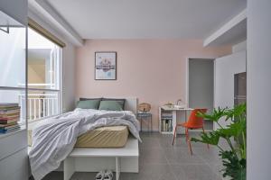 a bedroom with a bed and a table and chairs at M Village Living Lê Văn Sỹ in Ho Chi Minh City