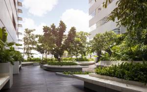 a courtyard in a building with trees and plants at TK Central Serviced Apartments in Phnom Penh