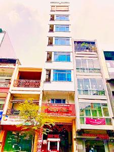 a tall white building with many windows on it at New Sunny Hotel in Ho Chi Minh City