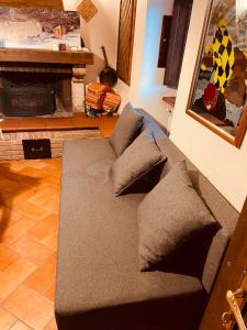 a couch sitting in a living room with a fireplace at Pescocostanzo chalet in Pescocostanzo