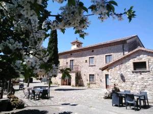 a building with tables and chairs in front of it at La Fonte in Sala Consilina