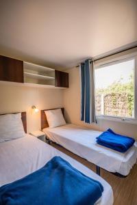 two beds in a room with a window at Sauvage in Quiberon +76 photos