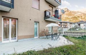 a patio with a table and chairs and an umbrella at Nice Apartment In Chatillon With Wifi in Châtillon