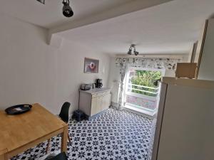 a small kitchen with a table and a refrigerator at Haus 51,8° in Bad Nenndorf