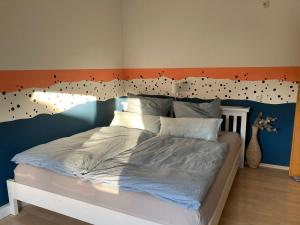 a bedroom with a bed with a headboard with dots on it at Haus 51,8° in Bad Nenndorf