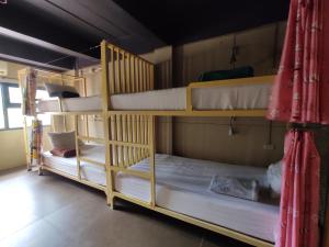 a couple of bunk beds in a room at Non La Mer Hostel - Bed & Yoga in Ko Lanta +30 photos