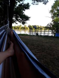 a person is holding a hammock in a park at Chalet avec spa à Libourne proche St-Emilion in Libourne