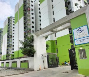 an apartment building with green and white at Metro Nook in Lucknow