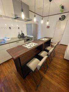 a kitchen with a wooden table and chairs at IslandHonu in Ishigaki Island