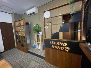 a island honolulu lobby with a clock on the wall at IslandHonu in Ishigaki Island