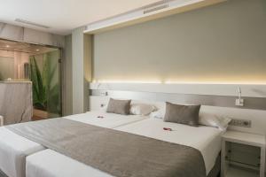 Cama o camas de una habitación en Hotel Aloe Canteras