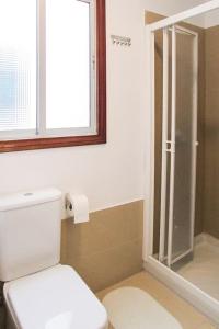 a bathroom with a toilet and a glass shower at Luminoso y acogedor in Las Palmas de Gran Canaria +30 photos