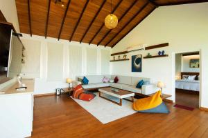 a living room with a couch and a table at River Arc in Panadura