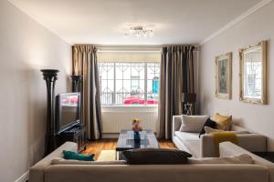 a living room with two couches and a tv at PickThePlace 3-bedroom Portman square in London
