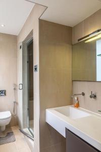 a bathroom with a sink and a shower and a toilet at PickThePlace 3-bedroom Portman square in London