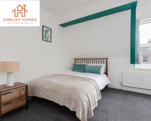 a bedroom with a bed and a dresser and a window at Stanley House - 7 doubles! - Parking! - City Links By Hinkley Homes Short Lets & Serviced Accommodation in Liverpool