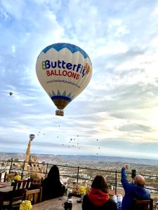 a hot air balloon is flying in the sky at Peristyle Cave Cappadocia- Special Class in Uchisar