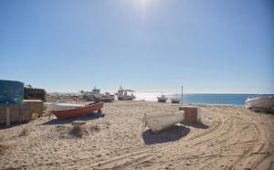 a group of boats sitting on a sandy beach at Apartamento La Pergola Cabo de Gata in El Cabo de Gata