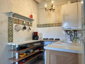 a kitchen with a sink and a counter top at Le jardin du roitelet in Semur-en-Auxois
