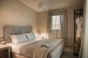 a bedroom with a bed with a tray on it at Ammos Suite-Grand Blue Beach Residence in Lixouri