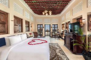 a bedroom with a large white bed in a room at Al Maya Island & Resort in Abu Dhabi