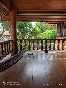 a hammock on the porch of a house at Chanmuang guesthouse in Mae Hong Son