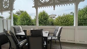 a porch with a table and chairs and a gazebo at Villa Sonneck - Wohnung 7 in Ostseebad Sellin