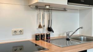 a kitchen with a sink and a counter top at Villa Sonneck - Wohnung 7 in Ostseebad Sellin