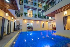 a swimming pool in the middle of a building at Hoi An Paradise Villa in Hoi An