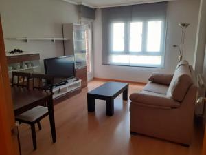 a living room with a couch and a table at El pisito de Irene in Béjar