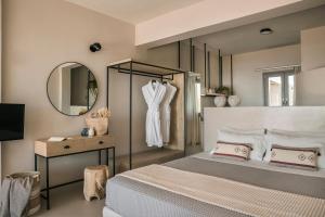 A bed or beds in a room at Votsalo Suite-Grand Blue Beach Residence
