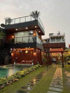 a house with a swimming pool in front of it at Villa SB Pacet in Sajen