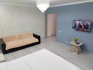 a living room with a couch and a tv at ЖК комфорт in Kokshetau
