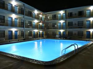 a large pool in front of a hotel at night at Seasons Florida Resort in Kissimmee