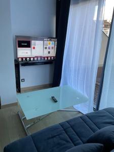 a table with a remote control sitting on top of a couch at Superbe studio front de neige la joue du loup in Le Dévoluy