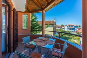 a patio with a table and chairs on a balcony at Apartments villa MaVeRo in Banjole