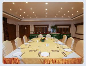 a large meeting room with a large table with chairs at Hotel Sasthapuri in Kozhikode