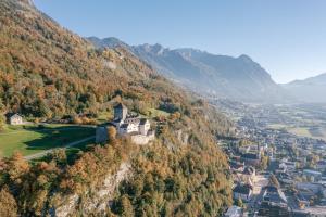 an aerial view of a castle on a mountain at Gorfion Familotel in Malbun