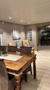 a dining room with a wooden table and chairs at Mountainside Lodge - Breivikeidet in Tromsø