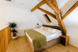 una camera con letto in una stanza con travi in legno di Resort Village Majer - Bela krajina a Gradac Altre 79 foto