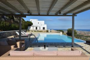 a villa with a swimming pool with a view at Villa Oliviers · Deluxe Villa - Infinity Pool & Helipad in Naousa