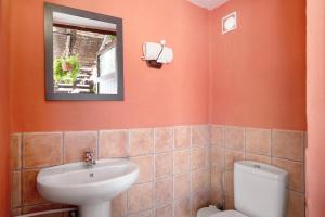 a bathroom with a sink and a toilet and a mirror at Casa Golondrina in Teguise +14 photos