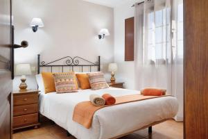 a bedroom with a large bed with towels on it at Casa Golondrina in Teguise