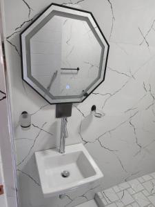 a bathroom with a sink and a mirror on the wall at Sea Views at 10 South in Durban