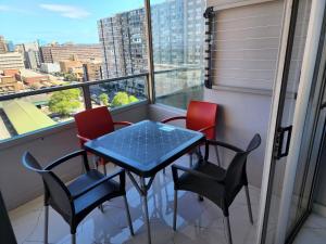 a table and chairs on a balcony with a view at Sea Views at 10 South in Durban