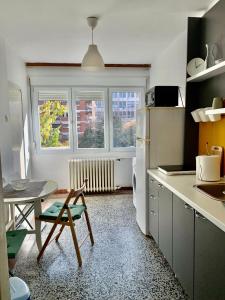a kitchen with a table and a chair in it at Star apartment in Belgrade