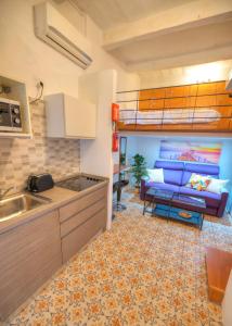 a kitchen and a living room with a bunk bed at Cozy & cute studio in the heart of Valletta GOVAL2 in Valletta