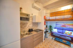 a kitchen with a sink and a loft bed at Cozy & cute studio in the heart of Valletta GOVAL2 in Valletta