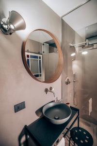 a bathroom with a sink and a mirror at Casa 3D'Oro Palermo in Palermo